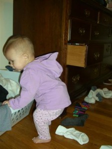 Josie putting socks in the laundry