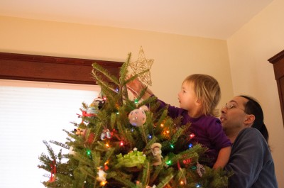Celia putting the star on the tree