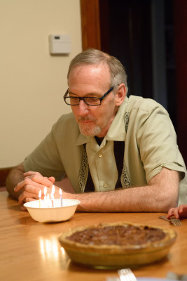 Mike blowing out his candles in some ice cream