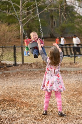 Josie pushing Ewan in the swing